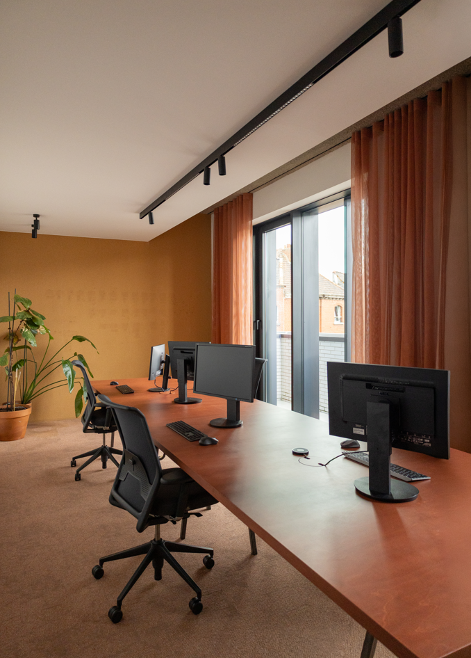 Privaat kantoor met werkplekken, bureaus en gordijnen